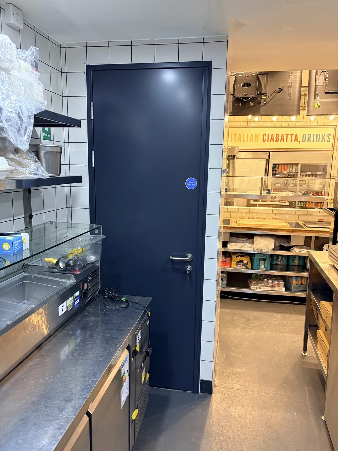 Completed dark fire door installation in commercial kitchen