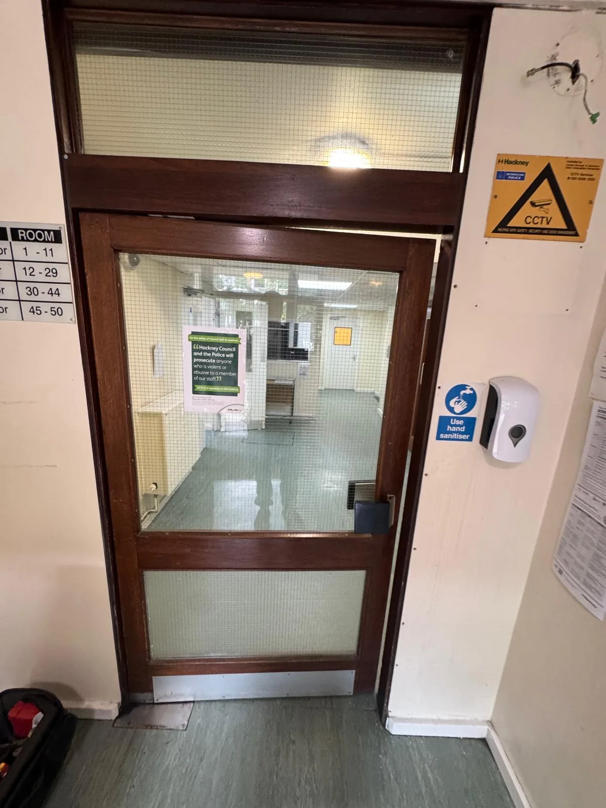 Existing glazed communal corridor door before replacement, opposite side