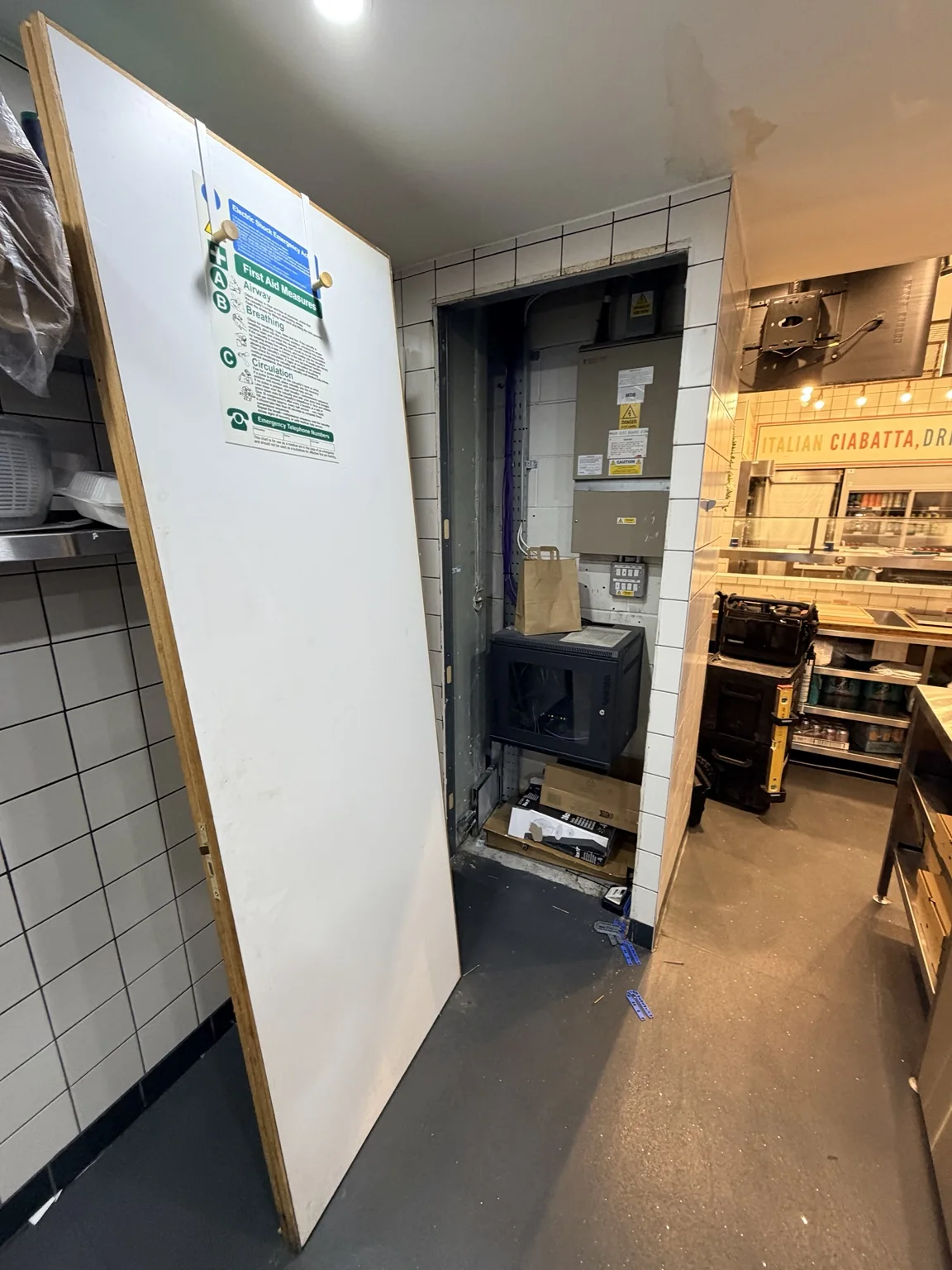 Existing service-area door before replacement in a commercial kitchen