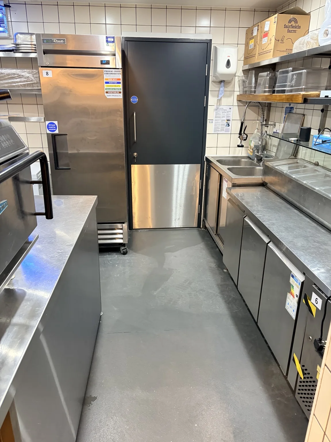 Reverse side of completed commercial kitchen fire door with stainless steel protection panel