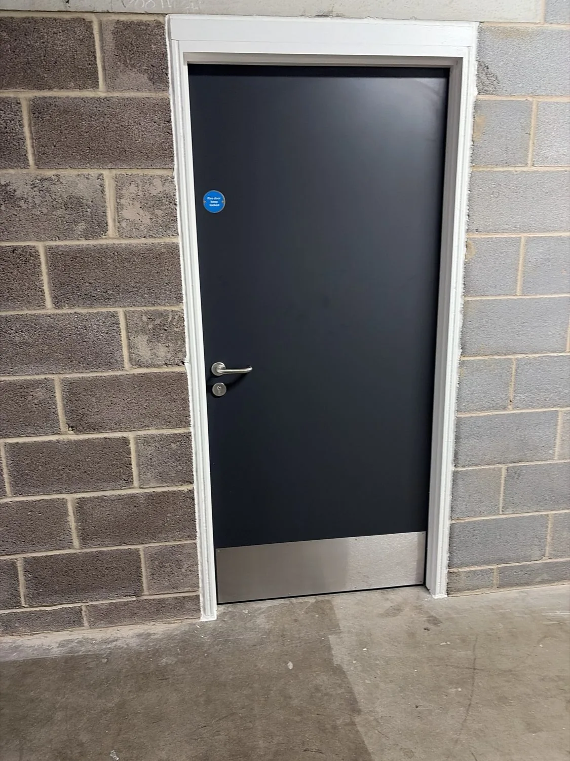 Single fire door with stainless steel lower protection